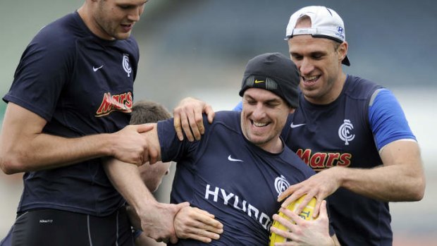 Heath Scotland (centre) will line up for his first pre-season match against Adelaide, but Chris Judd (right) won't be playing.
