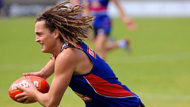 Hair raising: Luke Dahlhaus strides out at training this week: ''Hard work does pay off,'' he says.