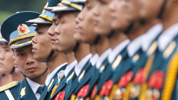 An officer checks the alignment of the honour guard before a welcoming ceremony for Japan's Prime Minister Shinzo Abe in Hanoi.
