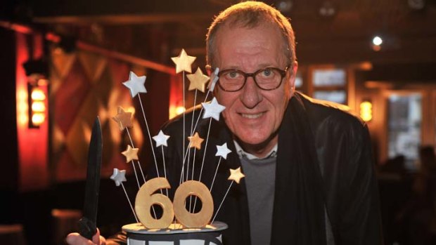 Geoffrey Rus celebrates his shared milestone at the festival with a cake.