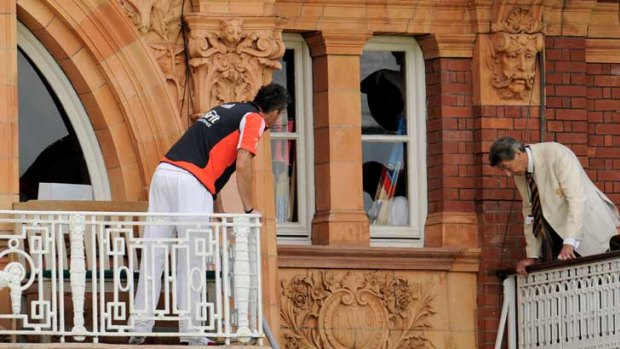 England's Kevin Pietersen (left) and an MCC steward look at a broken dressing room window and glass at Lord's.