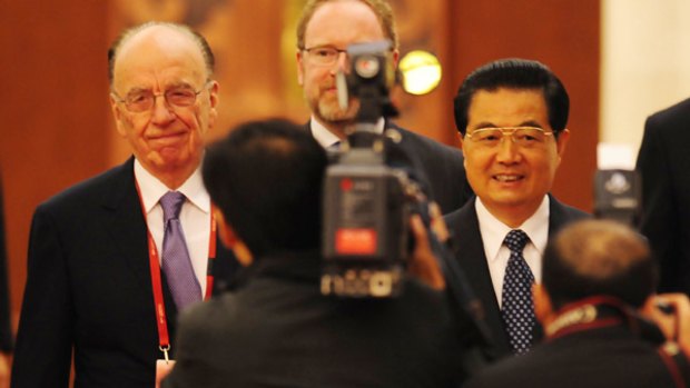 Rupert Murdoch and Chinese President Hu Jintao arrive for the opening ceremony of the World Media Summit in Beijing.