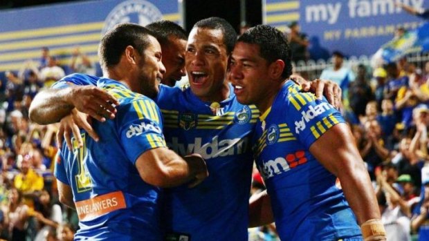 William Hopoate is swamped by teammates after scoring for the Eels.