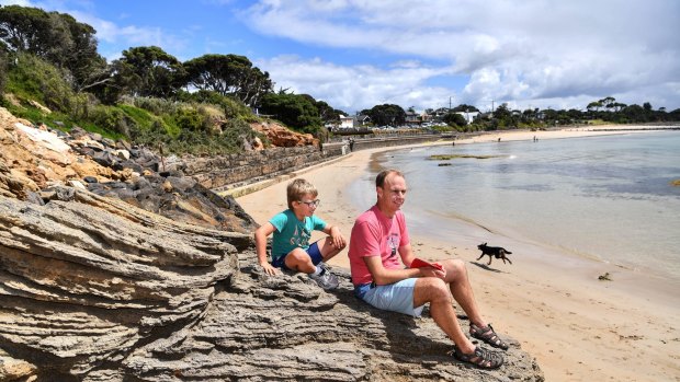 James Cotton with his son George and their dog Tilly at Point Lonsdale front beach.