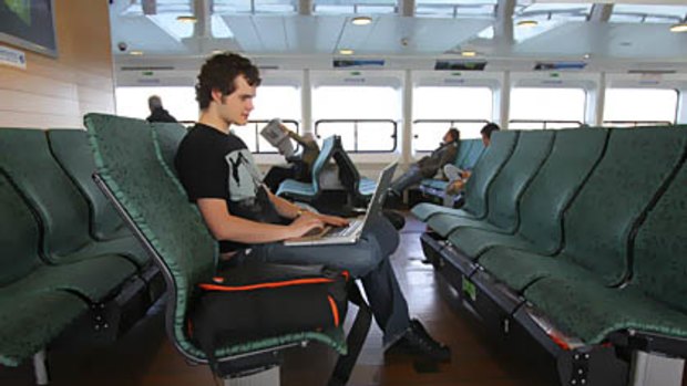 Daniel Brown 19 years old of Manly uses free Wi-Fi on the Queenscliff ferry to Manly.
