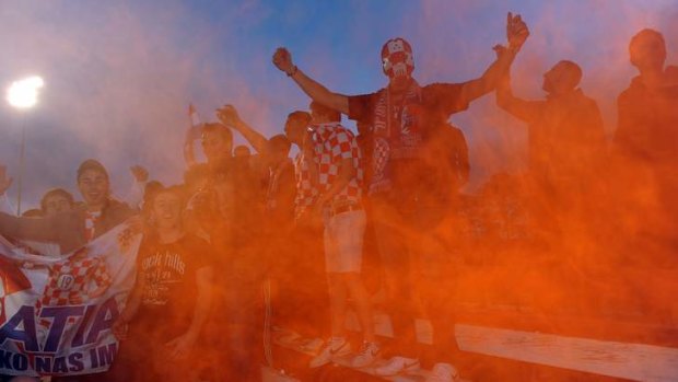 Canberra FC fans let off flares early in the game against Olympic in 2011. Heather Reid says capital Football will adopt a firm stance on misbehaving supporters.