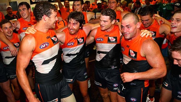 We've done it: GWS players celebrate their shock win over cross-town rival Sydney on Saturday night.