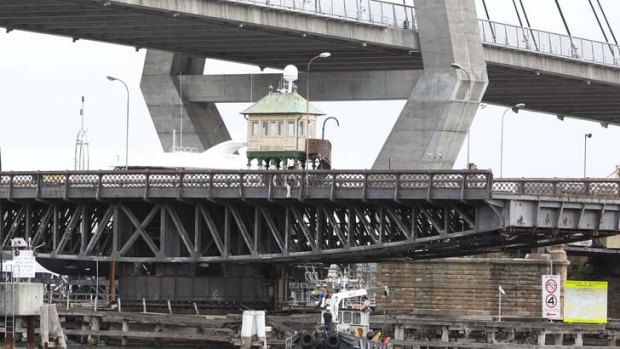 Two eras: The sleeker Anzac Bridge towers over the Federation-era Glebe Island Bridge, with its sections opened to allow water craft to travel through.