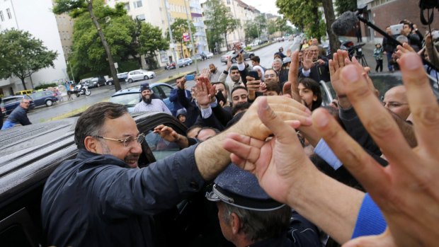 Al Jazeera's journalist Ahmed Mansour (left) is greeted by supporters after being released in Berlin, Germany.