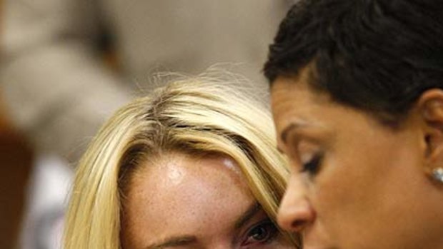 Lindsay Lohan weeps  beside her attorney Shawn Chapman Holley as the judge makes the order.