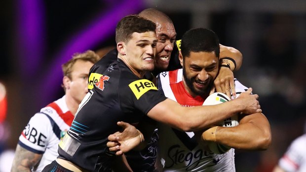 Defesive prowess: Nathan Cleary helps bring Isaac Liu down.