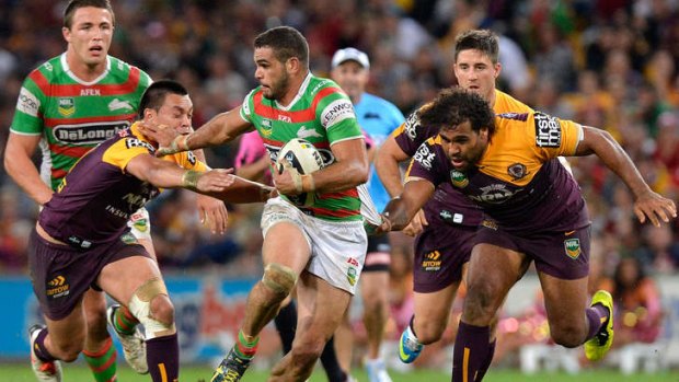 Like a bullet: Greg Inglis breaks through the Broncos defence at Suncorp Stadium on Friday night.