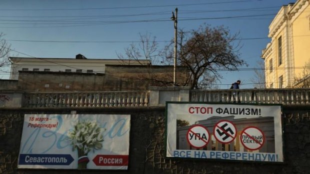 Tension: A billboard in Sevastopol featuring the swastika reads "Stop fascism, everyone go to the referendum".