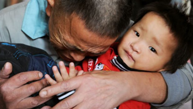 One boy saved among thousands who go missing...Wang Bangyin hugs his rescued son, kidnapped when he was 10 months old, in Guiyang, Guizhou province.