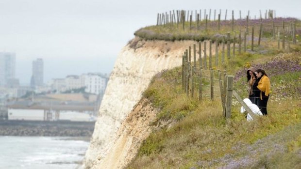 People lay flowers at the clifftop where Arthur fell to his death.