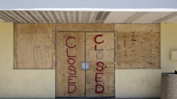 Plywood covers the doors of a 7-Eleven store ahead of Hurricane Irma in Madeira Beach, Florida.