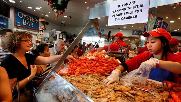 Fish fight ... busy scenes from the Sydney Fish markets herald the beginning of the 26-hour trade for Christmas.