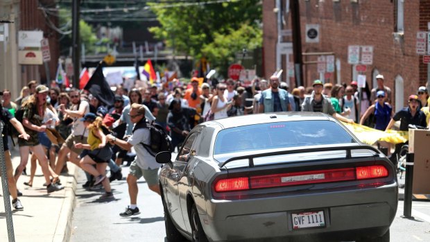 A vehicle drives into a group of protesters demonstrating against a white nationalist rally in Charlottesville.