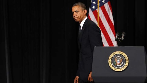 US President Barack Obama walks from the rostrum after speaking at a vigil held at Newtown High School for families of victims of the Sandy Hook Elementary School shooting.