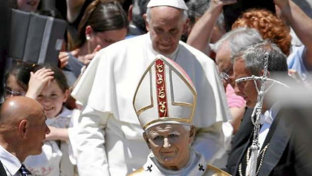 Miraculous: Pope Francis is presented with a statue in the likeness of late Pope John Paul II during the weekly audience in Saint Peter's Square at the Vatican.