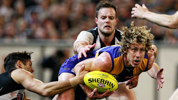 Caught Coaster: Eagle Matt Priddis is swamped by Magpies at the MCG last night.