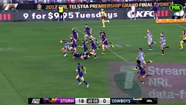 Pursued: Kyle Feldt is chased down by eight Storm defenders during the grand final.