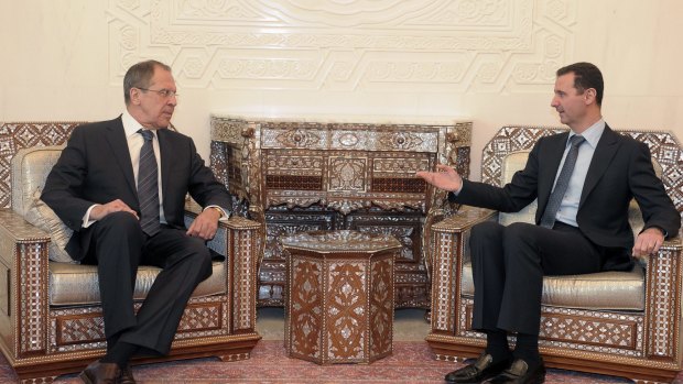 Syrian President Bashar al-Assad speaks with Russian Foreign Minister Sergey Lavrov in Damascus, Syria. Lavrov says that  Russian aircraft flying into Syria have been delivering weapons along with humanitarian supplies.