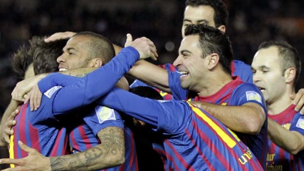 Lionel Messi, left, celebrates with teammates after scoring.