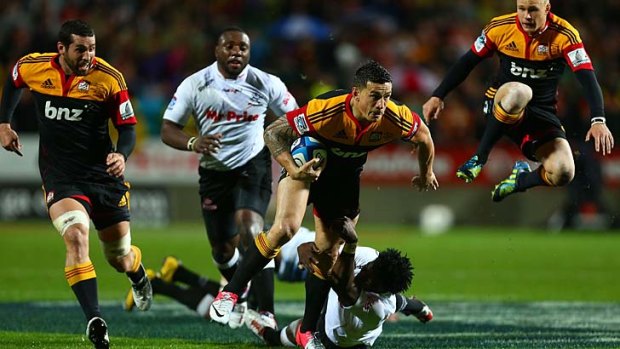 Star turn ... Sonny Bill Williams of the Chiefs breaks the tackle of Lwazi Mvovo of the Sharks.