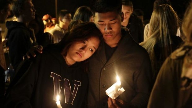 Students and community members attend a vigil after the shooting.