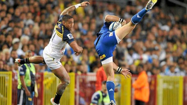 Mid-air struggle ... Joseph Tomane of the Brumbies and Gerhard van de Heever fly for the high ball.