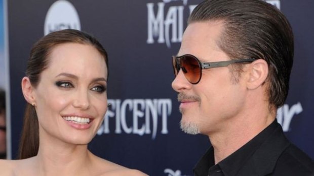 Angelina Jolie and Brad Pitt at the Maleficent premiere  before Vitalii Sediuk, jumped the barricade and touched Pitt’s face.