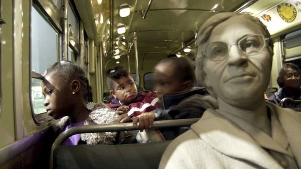 Strength and courage ... visitors with a statue of Rosa Parks on a replica bus at the museum in Montgomery that honours her fight for equality.