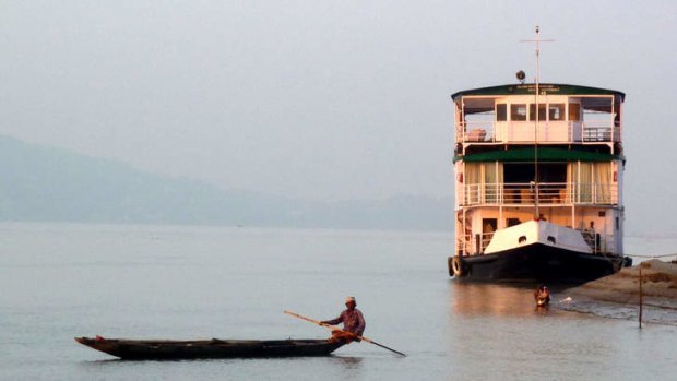 The RV Charaidew, a small colonial-style river ship, cruises the Lower Brahmaputra River in Assam,  India.