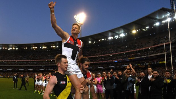 Leading light: St Kilda club champion Nick Riewoldt, carried off by cousin Jack, left, and teammate Josh Bruce.