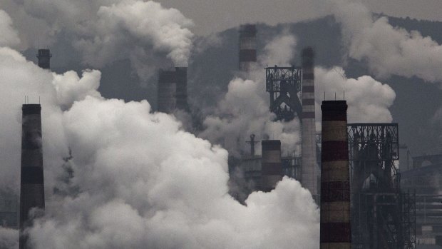 Smoke billows from smokestacks and a coal fired generator at a steel factory in the industrial province of Hebei, China.