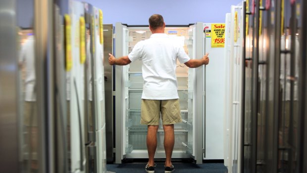 Buying the fridge rather than the food: A shopper looks at refrigerators at a Harvey Norman store in Sydney.