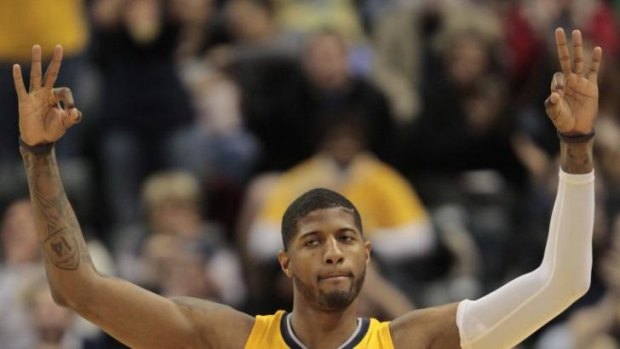 Indiana Pacers forward Paul George reacts after hitting a three-point shot against the Detroit Pistons in Indianapolis.