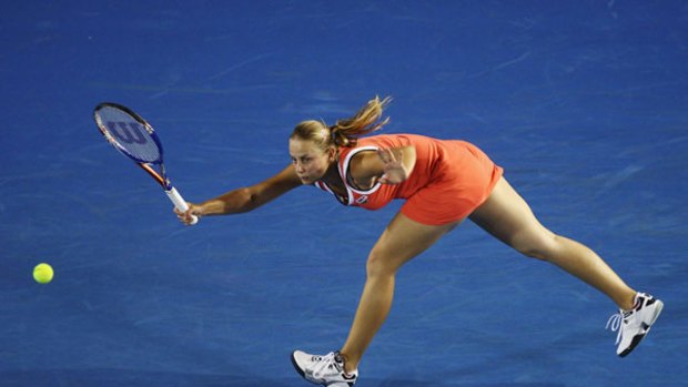 Orange crush ... Jelena Dokic labours on her way to a straight-sets defeat to Alisa Kleybanova in the first round at Melbourne Park last night. The Australian went down 6-1, 7-5.
