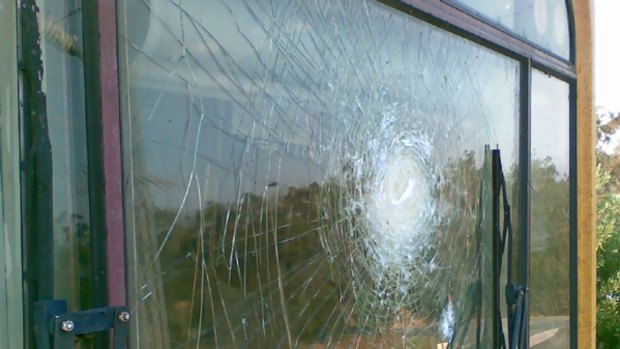 The shattered windscreen of the northbound Gold Coast train after vandals pelted it with rocks from above.