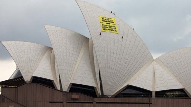 Forest activists drop a large banner off the roof of Sydney Opera House in a protest against retail giant Harvey Norman.