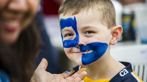 Edward Murphy (4) from Isabella Plains has his face painted at the Brumbies' meet the players day on Sunday.