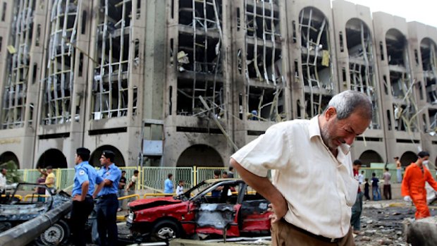 Slaughter ... an Iraqi weeps as rescuers search for survivors in the devastated Justice Ministry building.