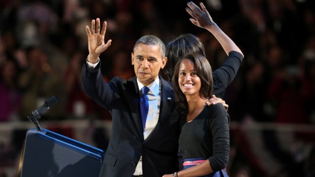 Poised and humble:  Malia Obama with her parents on stage in Chicago before her father delivered his victory speech on election night.