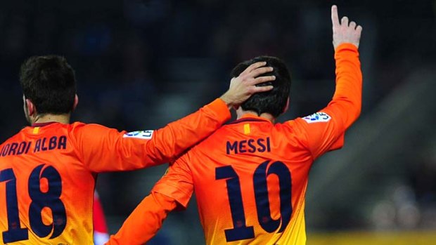 Lionel Messi celebrates with teammate Jordi Alba.