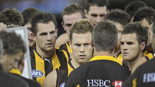 Luke Hodge (left) and Sam Mitchell (middle) give coach Alastair Clarkson their full attention.