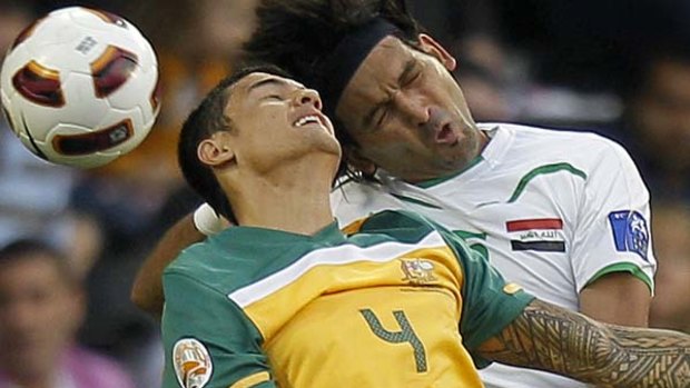 Australia's Tim Cahill, left, vies for the ball with Iraq's Hadi Aghili.