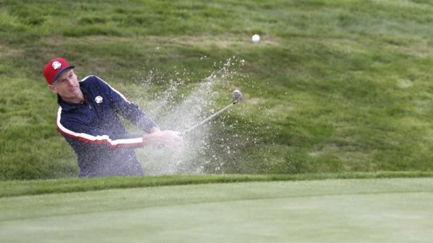 Jim Furyk of the US chips out of a bunker on the sixteenth green on Tuesday.