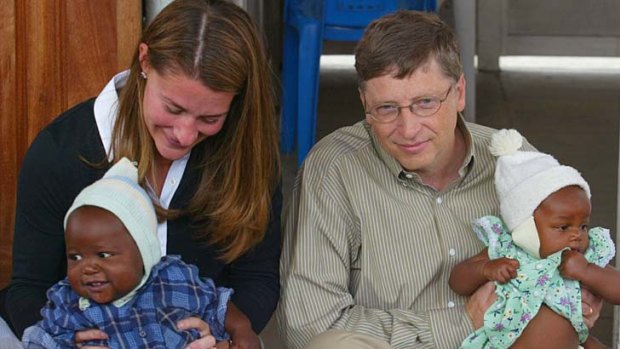 Bill Gates and his wife Melinda hold babies during a visit to the Manhica Health Research Centre in Mozambique