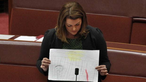 Greens Senator Sarah Hanson-Young tables drawings made by children held in the Manus Island detention centre.